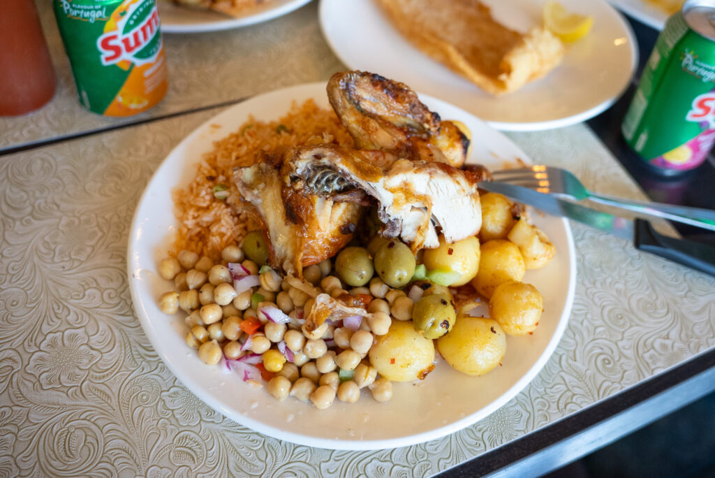 Traditional Portuguese dish with fish, potatoes, and chickpeas on a plate.